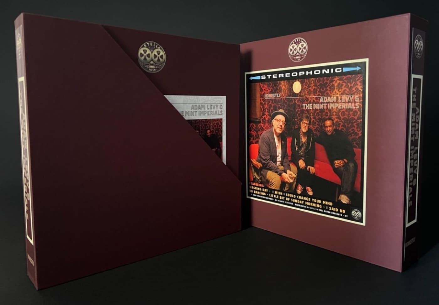 Two Adam Levy album boxes opened side by side showing album artwork