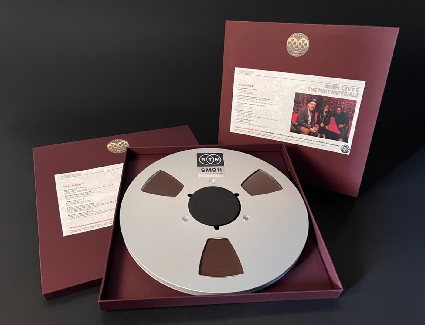 Adam Levy album package showing two burgundy boxes and professional RTM tape reel